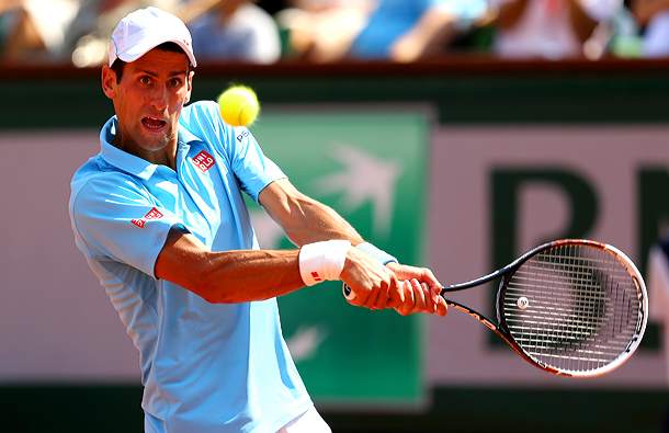 The white cap isn't enough to protect Djokovic from the heat. (Clive Brunskill/Getty Images)